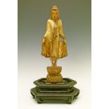 Chinese carved giltwood figure of a Buddha standing on lotus flower, hexagonal hardwood base,
