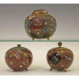 Three Japanese cloisonnÚ jars and covers, the larger of hexagonal form and decorated with Oni