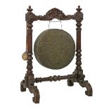 Late 19th/early 20th Century heavily carved oak framed floor standing dinner gong having mask head