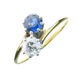 Diamond and sapphire two stone crossover ring, the diamond of approximately 0.4 carats, size L, 2.3g
