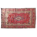 Modern Middle Eastern style carpet decorated with a central medallion on a red ground within multi