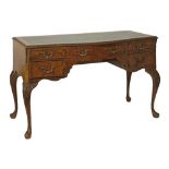 Reproduction burr walnut kneehole writing table, inset leather writing surface, carved edge and