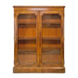 Victorian figured walnut cabinet bookcase fitted three adjustable shelves enclosed by a pair of