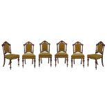 Set of six late Victorian carved walnut arch top dining chairs, each having a carved gadrooned crest