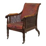 George IV mahogany bergere chair, the scroll back and arms with split cane panels, conforming seat