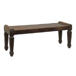 19th Century mahogany window seat standing on tapered fluted spade supports, 120cm long