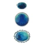 Collection of three blue/green Ruskin pottery brooches, one circular and two oval, the largest 4.1cm