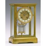 Late 19th/early 20th Century French brass cased four glass mantel clock, the brass dial having