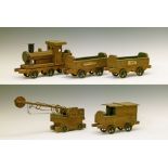 Vintage wooden toy train comprising: locomotive and tender, two coal wagons and a crane, bears label