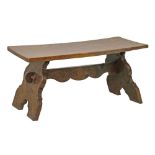 Solid pollard oak rectangular top low table standing on trestle supports united by a decorative