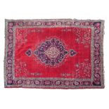 Middle Eastern rug decorated with a central medallion on a red ground within multi borders, 371cm
