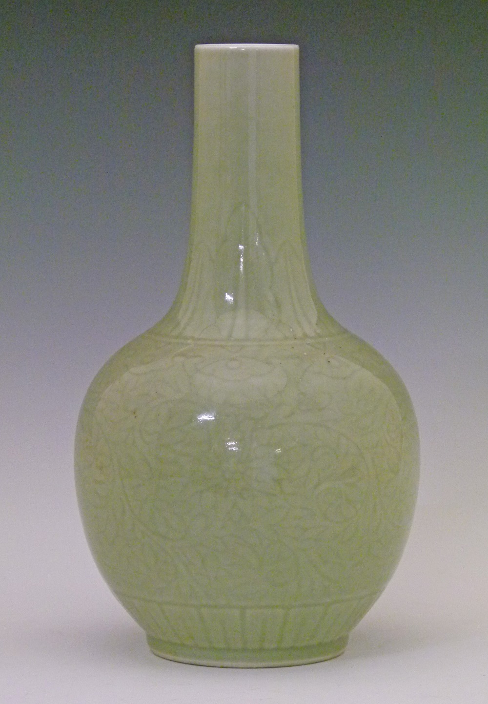 Chinese celadon glazed ovoid vase having a slender tapered neck and with allover foliate scroll