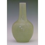 Chinese celadon glazed ovoid vase having a slender tapered neck and with allover foliate scroll