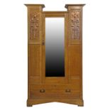Liberty style oak wardrobe having a drop centre cornice, single bevelled mirror panel door flanked
