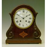 Late 19th/early 20th Century inlaid and carved mahogany cased mantel clock, the white enamel dial