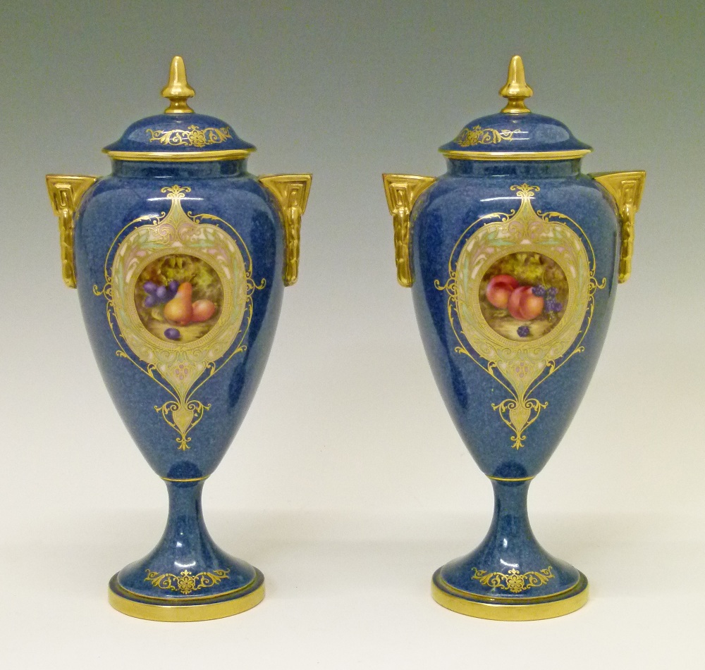 Pair of Royal Worcester urn shaped vases and covers by William Bee, each having a circular reserve