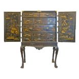 George III chinoiserie style black lacquered chest on stand, having allover landscape and foliate