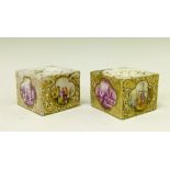 Pair of Meissen square inkwells, each having polychrome and puce painted reserve panels depicting