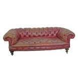 Early 20th Century three seater Chesterfield settee upholstered in deep buttoned dark red leather