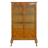 Walnut display cabinet having allover chinoiserie style gilt lacquered decoration, fitted three