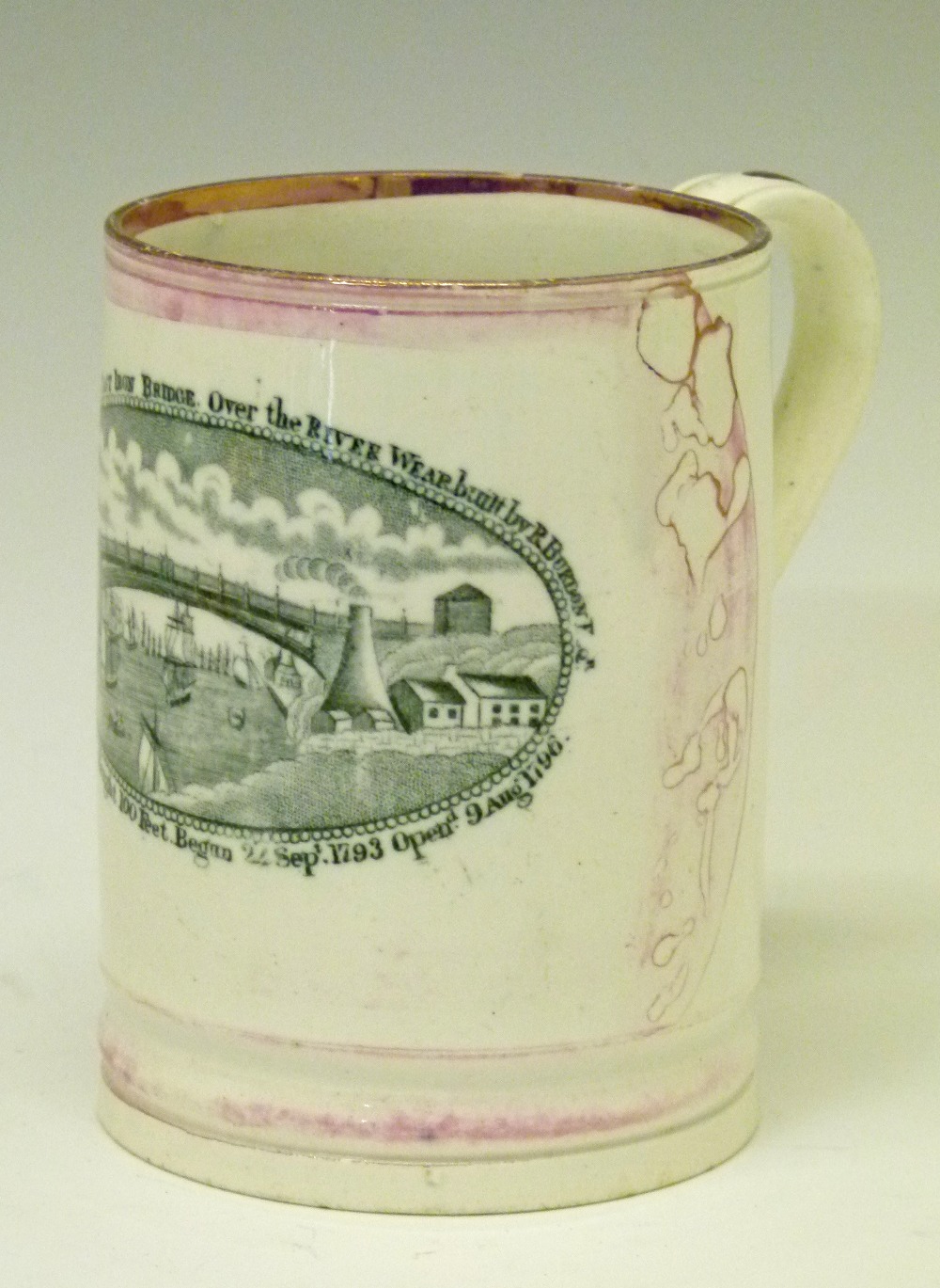 19th Century mottled pink lustre glazed pottery mug having black transfer printed decoration