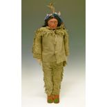 Skookum American Indian character doll having a composition head, black hair in plaits, straw