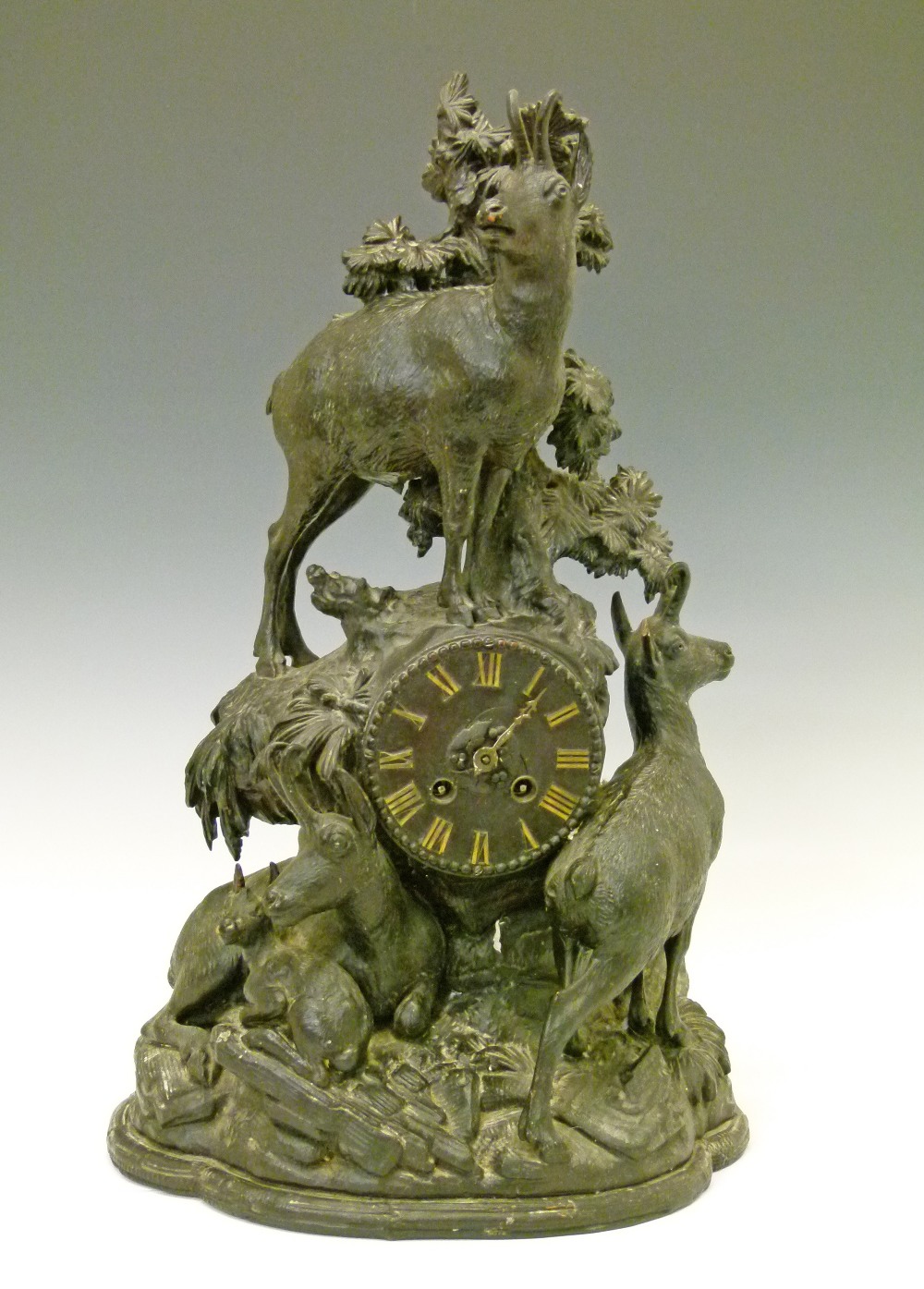 Late 19th Century Black Forest mantel clock, the carved case decorated with mountain goats, dial