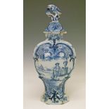 19th Century Dutch Delft baluster vase and cover having blue and white painted decoration