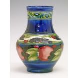 William Moorcroft baluster vase decorated with a banded Pomegranate pattern on a blue ground, base