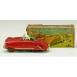 Schuco Radio 4012 tin plate clockwork car with musical movement, having a red body and green