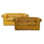 Pair of two seater Chesterfield settees upholstered in brass studded deep buttoned gold/brown