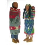 Pair of Skookum American Indian character dolls depicting a male and female, she with a papoose on