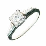 Diamond single stone ring, the Princess cut of approximately 0.8 carats, between tapering baguette