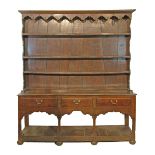 18th Century oak Welsh dresser, the plate rack with moulded cornice, shaped apron below and fitted