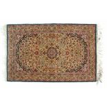 Good quality modern Persian silk rug decorated with a central medallion amongst tight-knit