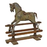 Late 19th/early 20th Century wooden rocking horse on a swinging trestle base, bearing traces of