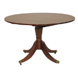 Regency mahogany circular snap top breakfast table standing on a reeded turned and tapered pillar