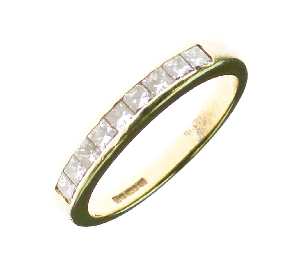 Diamond 18ct gold half hoop ring, the nine channel set Princess cuts totalling approximately 0.54