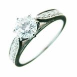 Diamond single stone ring, the brilliant cut of approximately 0.7 carats, between shoulders set with