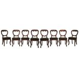 Set of eight Victorian walnut buckle back dining chairs, each having a stuffed seat and standing