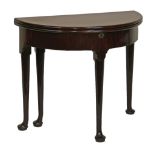 George III red walnut demi lune fold over supper table, the hinged cover opening to reveal a storage