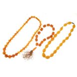 Row of graduated amber beads, the thirty-seven round beads of approximately 1.1cm to 1.5cm diameter,