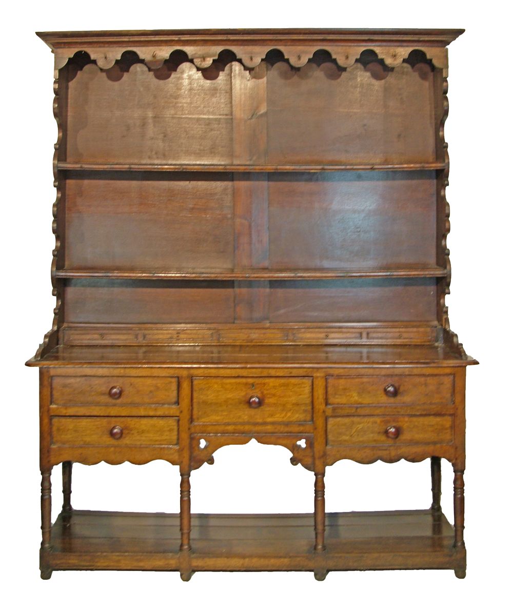 19th Century oak high dresser, the plate rack with moulded cornice, shaped apron below and fitted