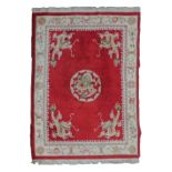 Modern Chinese carpet typically decorated with dragons on a red ground within multi borders, 375cm x