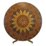 Elaborate parquetry inlaid circular snap top dining table standing on a turned pillar and
