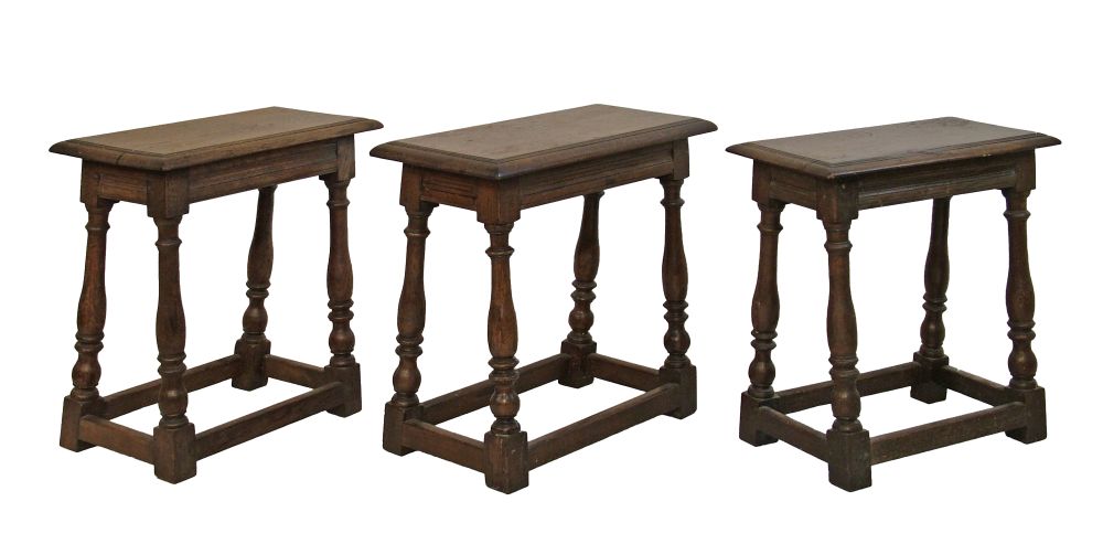 Three antique 17th Century style oak joint stools, each standing on turned supports united by