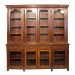 Victorian walnut Gothic design two section library bookcase, the upper section having a moulded