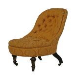 Victorian spoon back nursing chair upholstered in deep buttoned floral patterned pink fabric and