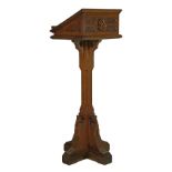 Late 19th/early 20th Century light oak Gothic style lectern having carved decoration and standing on