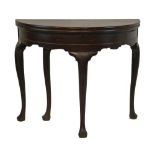 Mid 18th Century mahogany demi lune fold over supper table having a hinged box top and standing on